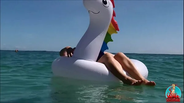 my husband, my unicorn and me in erotic play on a public beach.